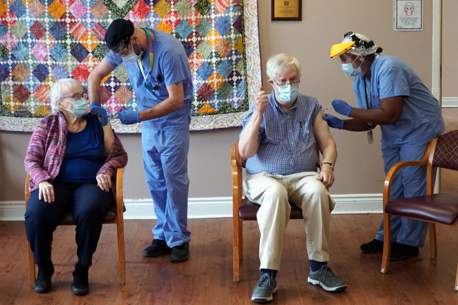 Two long-term care home residents getting their COVID-19 vaccine