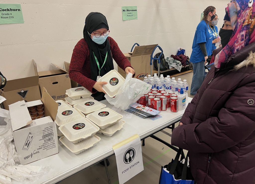 Person packing food for community member.
