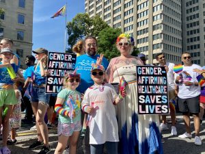 Emily Materick, Clinic Manager at Comprehensive Treatment Centre, marches in the Toronto Pride Parade with family.