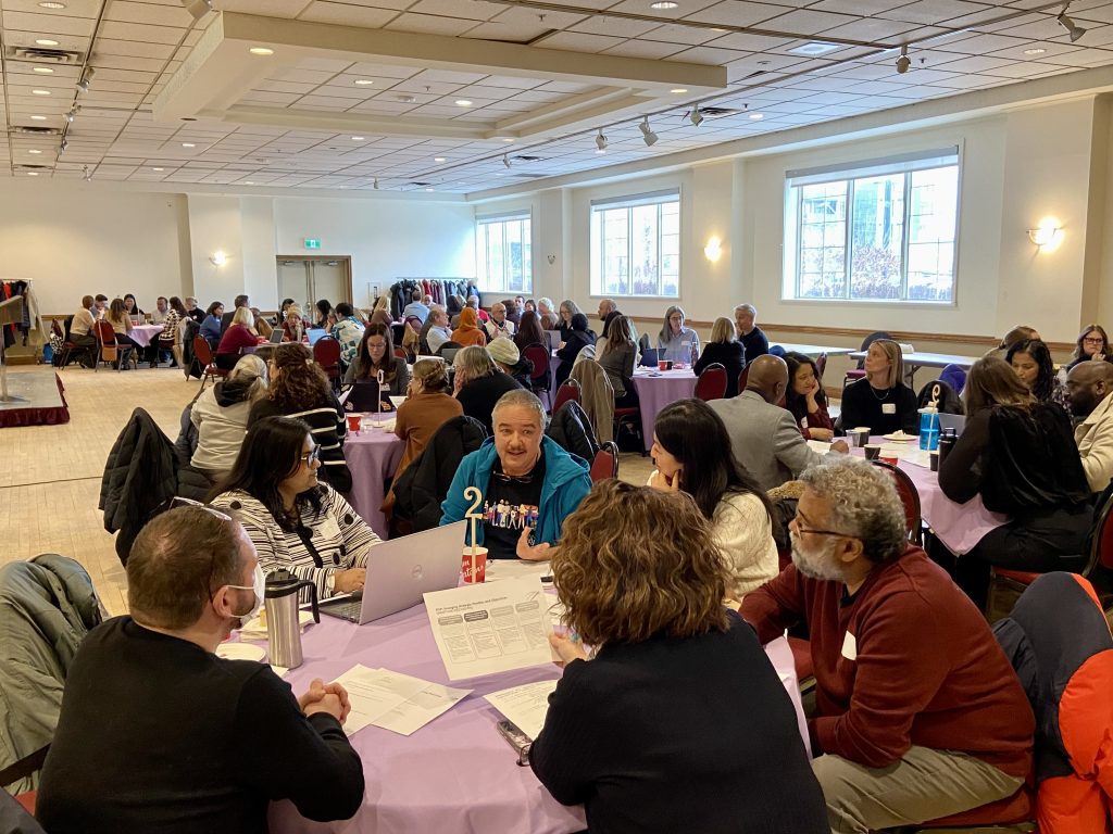 A group of people at a table talking.