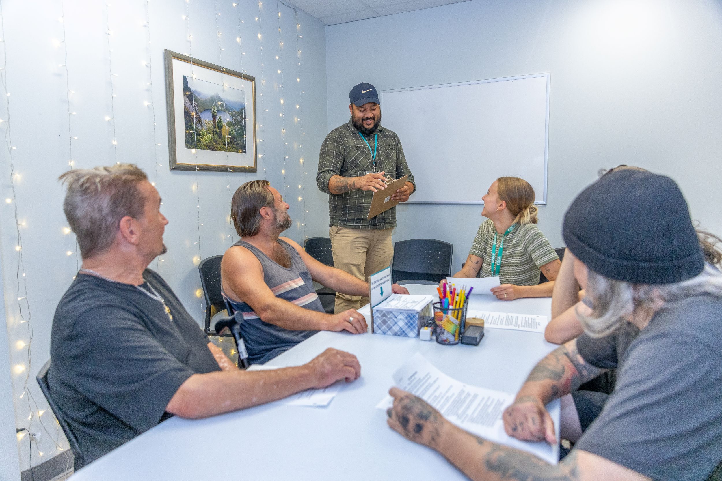 A group of people sit at a table, talking.
